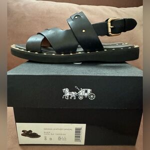 Coach Gemma leather sandal with gold rivet detail.